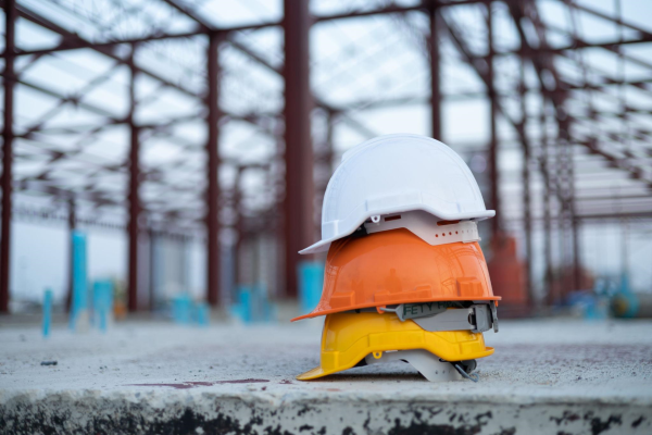 hard hats lined up by color on a construction